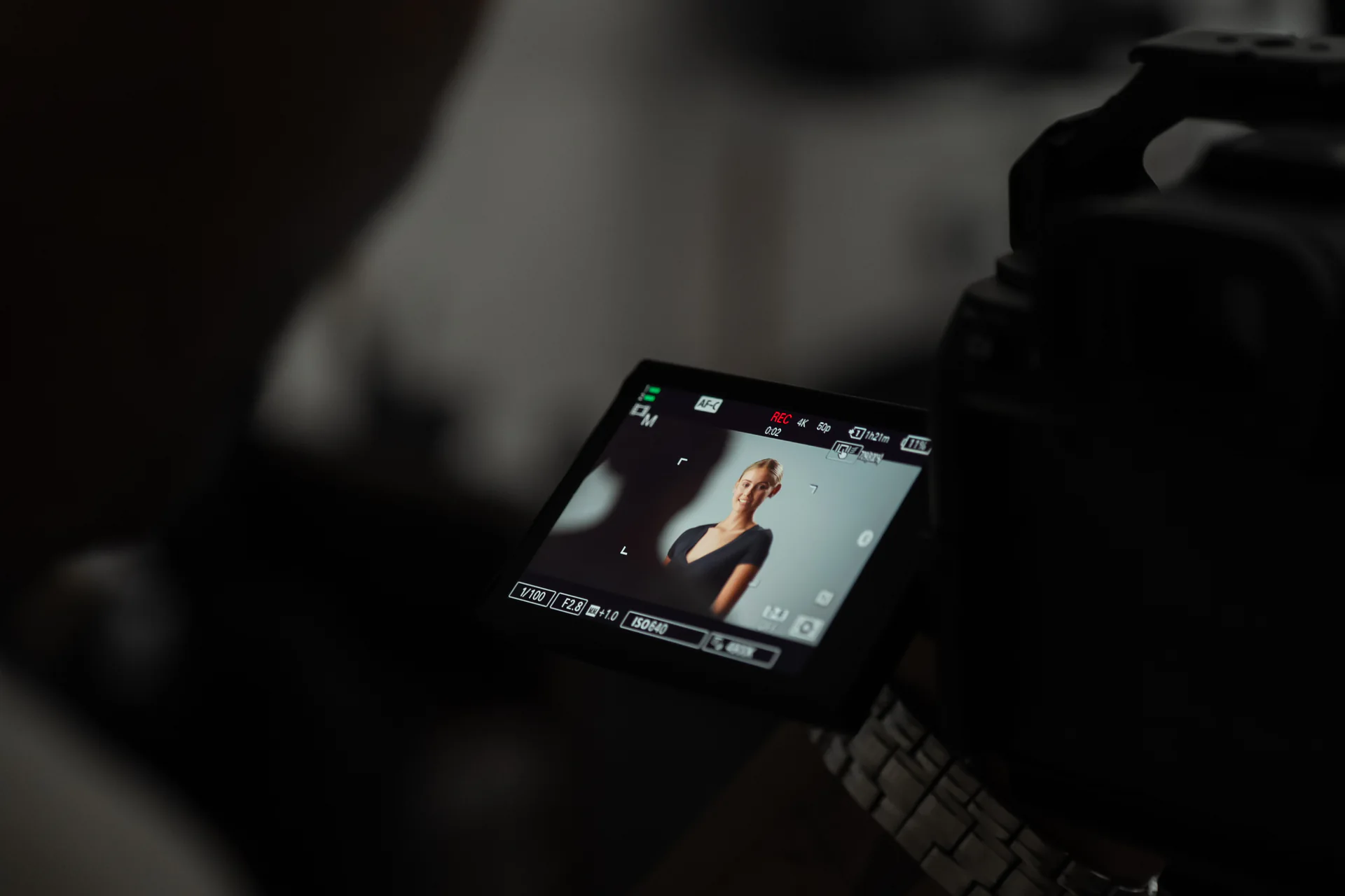 A camera monitor framing a portrait during a Studio GQ production