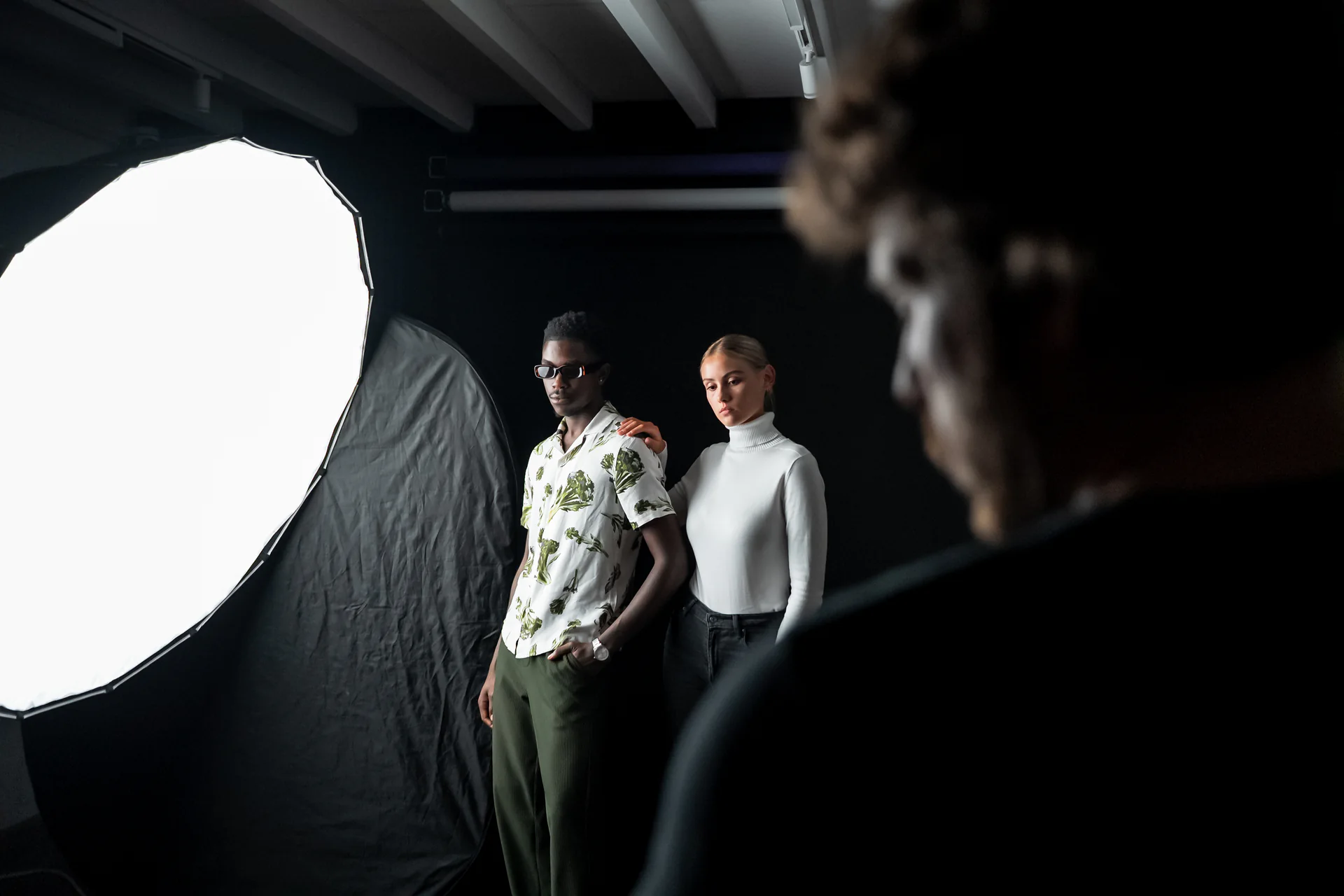 Two subjects positioned beside a large softbox during a studio setup
